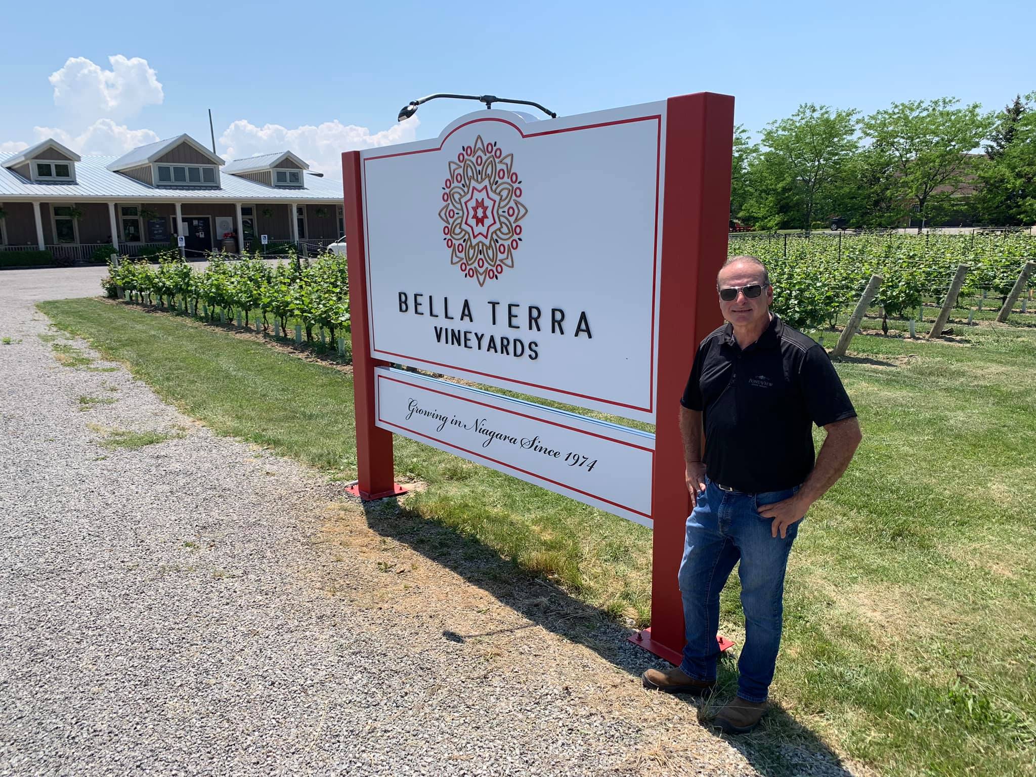 Lou Puglisi next to new Bella Terra Vineyards sign